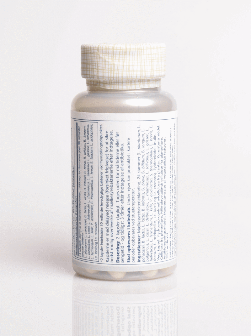 Weiße Flasche mit gittergemustertem Deckel, ausführlichem Etikett und sichtbaren Tabletten am Boden, auf weißem Hintergrund